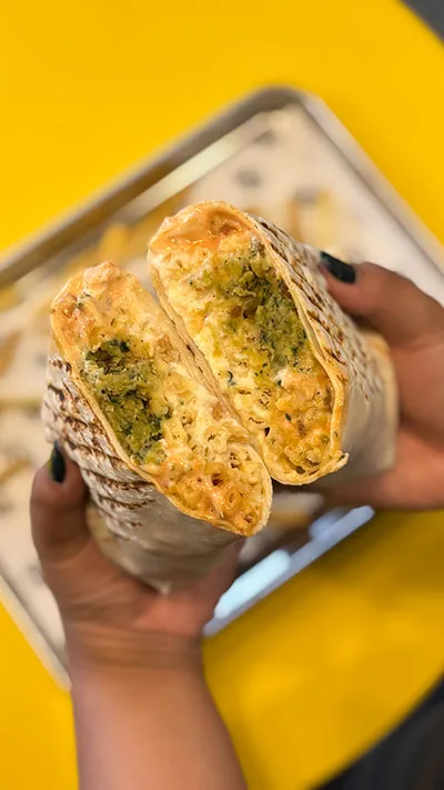 French taco cut open, filled with fries and melted cheese