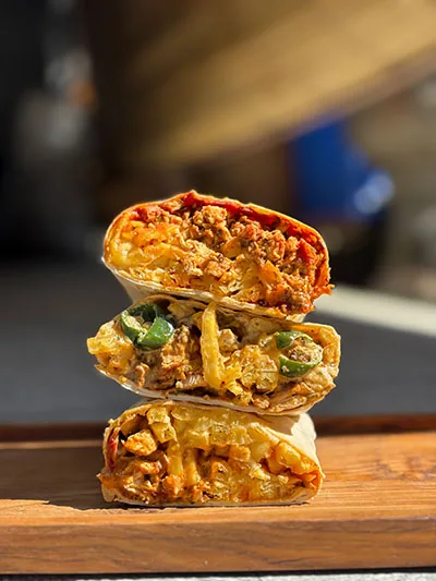 French tacos halves stacked on a board at Bon Appétit Bali
