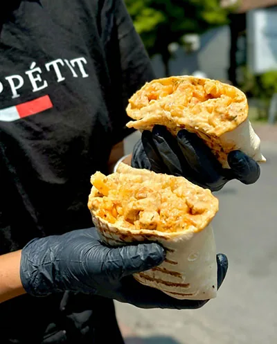 French taco cut open, filled with fries and chicken