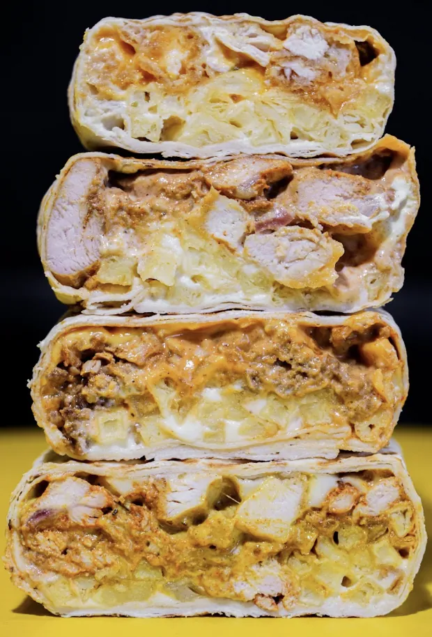 Cross-section of Bon Appétit French tacos showing fries, meat and melted cheese sauce