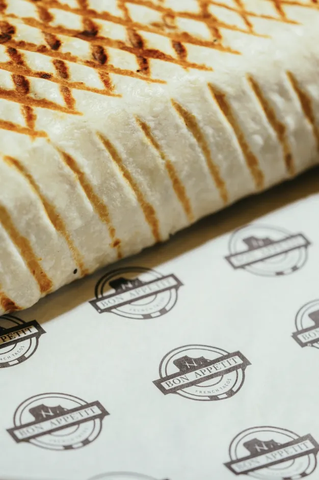 Grilled French tacos tortilla on Bon Appétit branded paper
