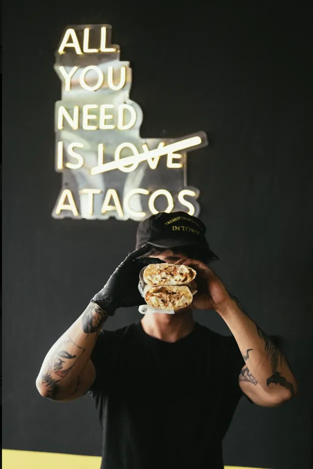Neon sign reading All you need is tacos inside Bon Appétit Bali