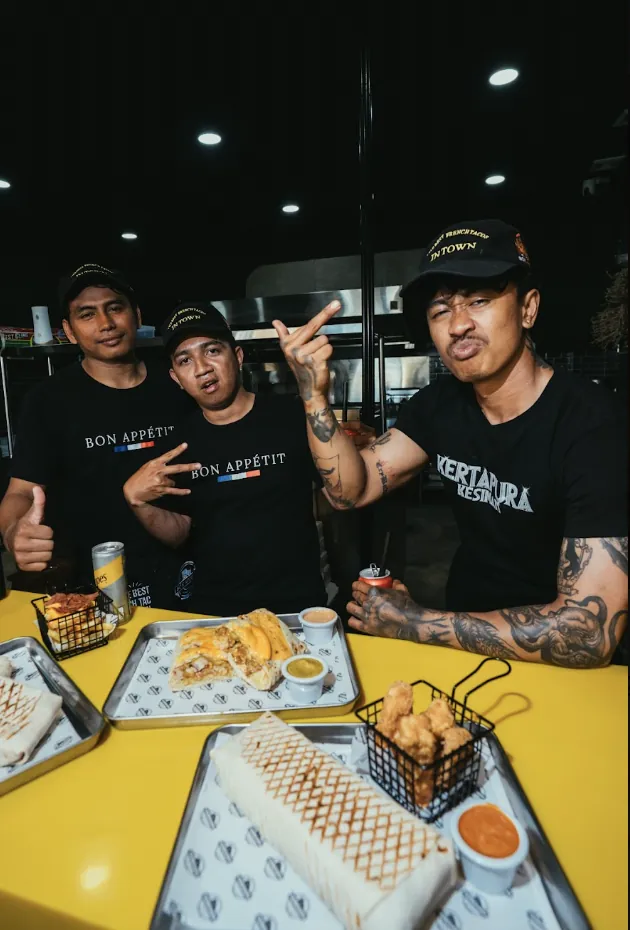 The Bon Appétit Bali kitchen team with French tacos, loaded fries and chicken tenders